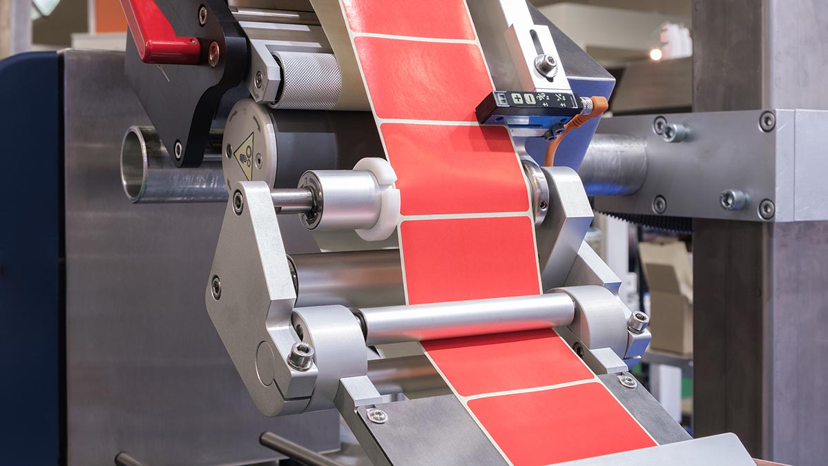 Fragment of the conveyor of the pharmaceutical labeling machine. Abstract industrial background.